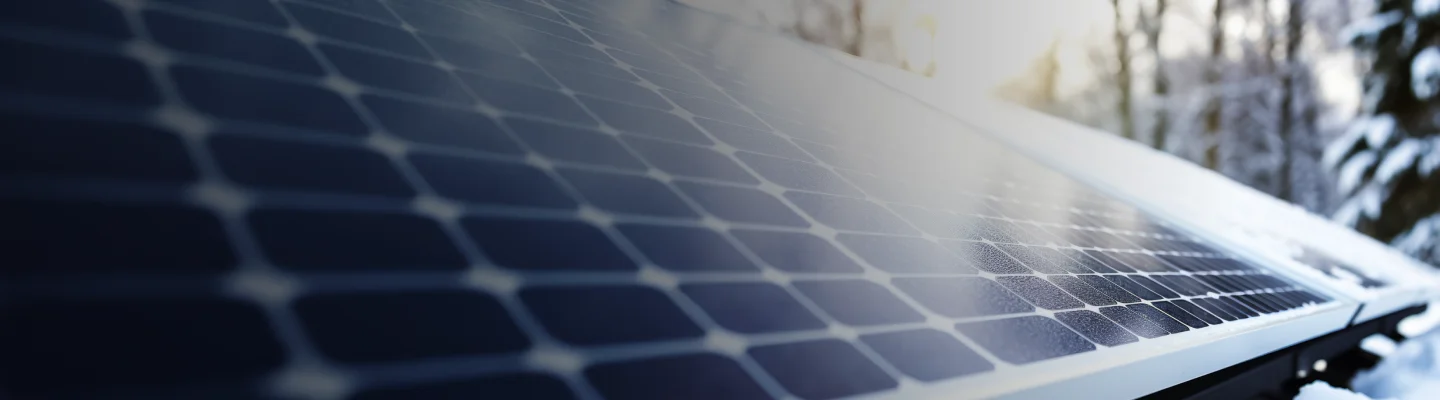 Solar panels covered in light snow during winter
