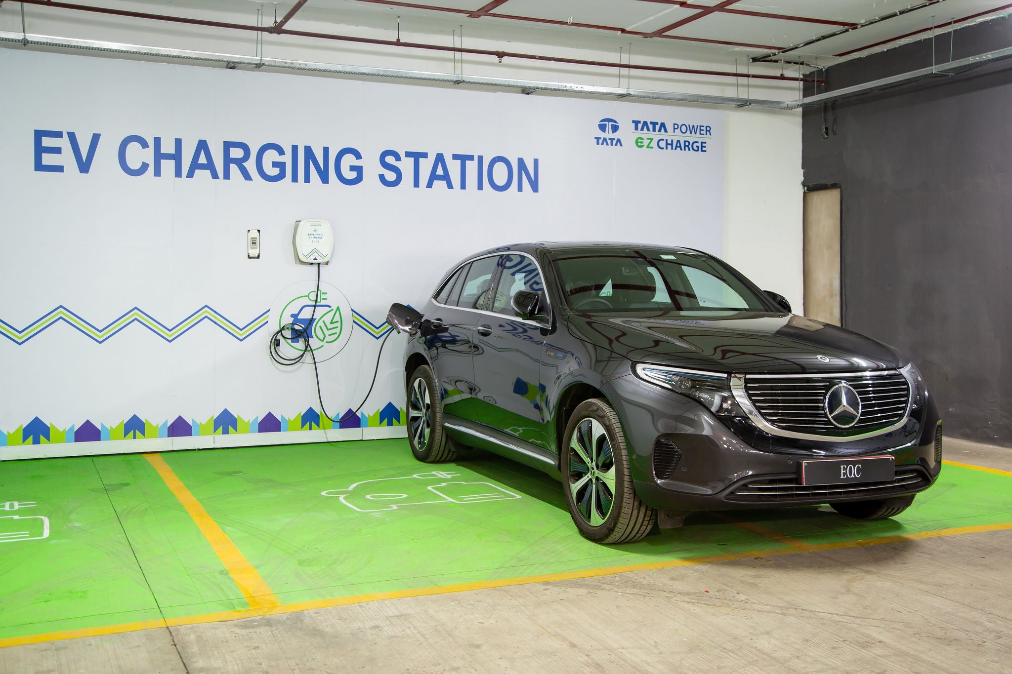 A black Mercedes plugged into a Tata Power EZ Charge EV charging station