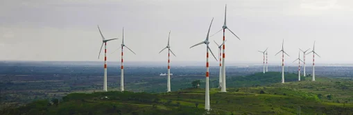 Tata Power wind turbines generating clean energy in open fields
