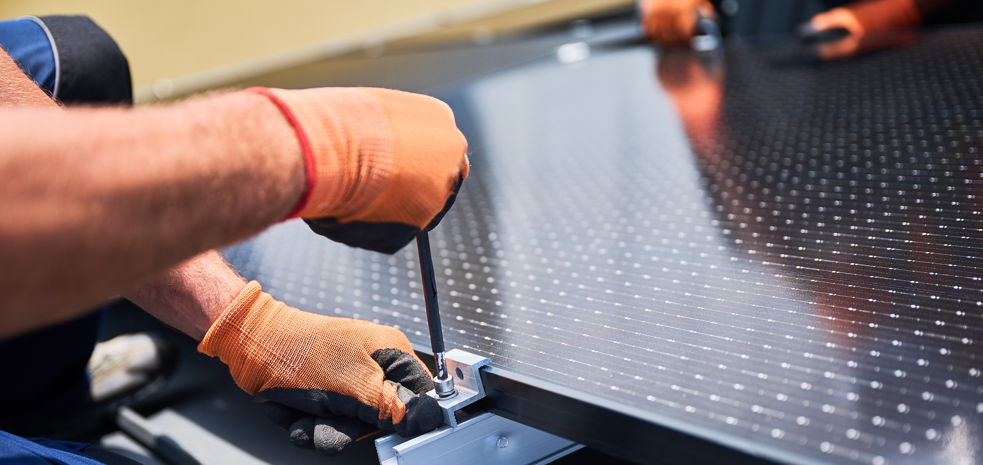 Technician performing solar panel installation