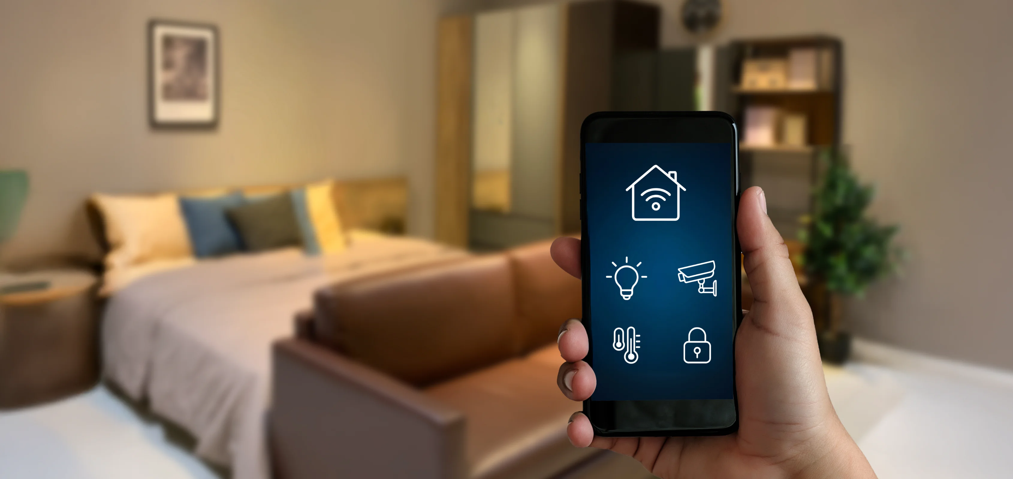 Smart home app interface on phone screen showing Wi-Fi, camera, and thermostat icons