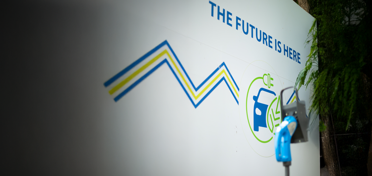 EV charging station with 'The Future Is Here' sign