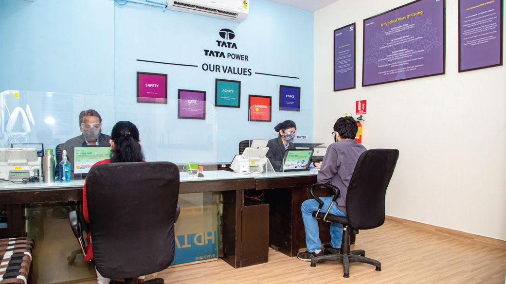 Customer service representative assisting a customer at a Tata Power Customer Relations Centre